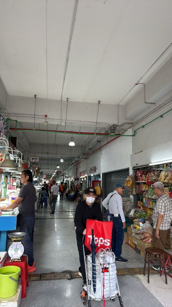 Central aisle of Samyan Wet Market with shoppers and stalls